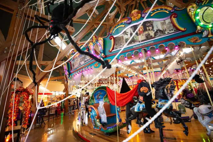 Spider web covering Halloween-decorated Carousel