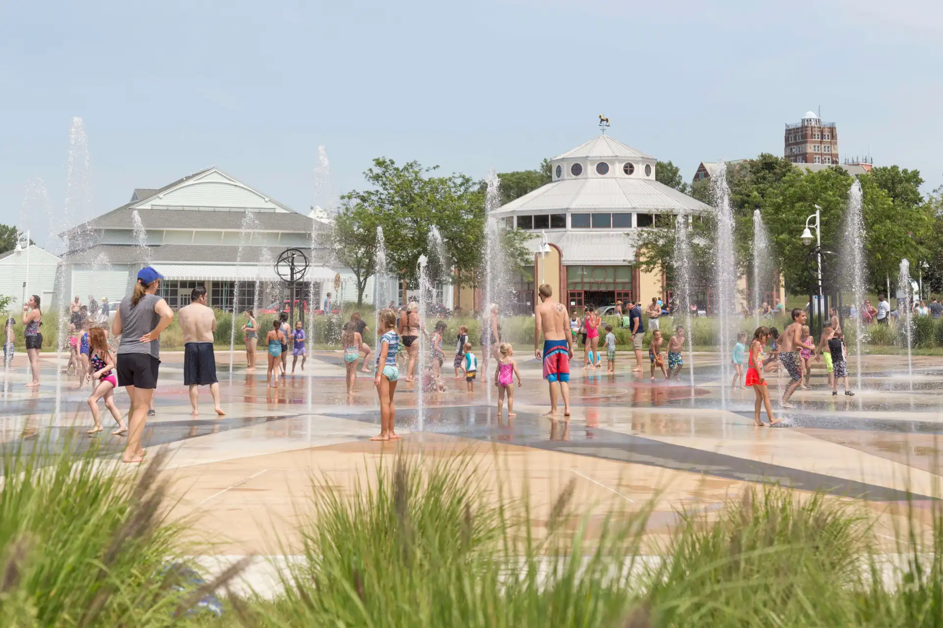 children playing at the Whirlpool Compass fountain