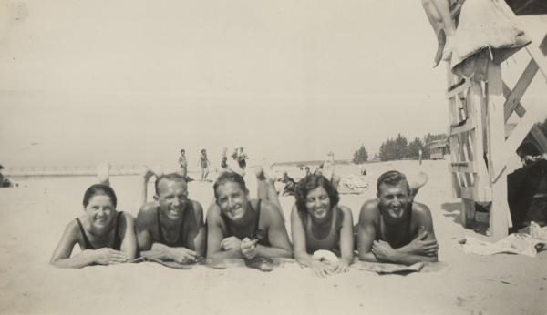 historic photo of 5 people laying on Silver Beach