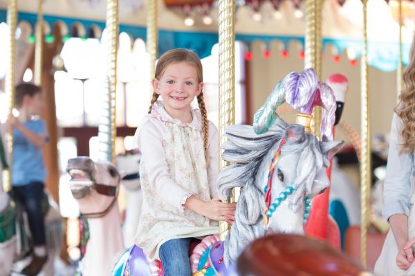 young girl riding on the Carousel