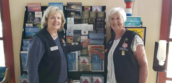 volunteers adding pamphlets on the brochure rack