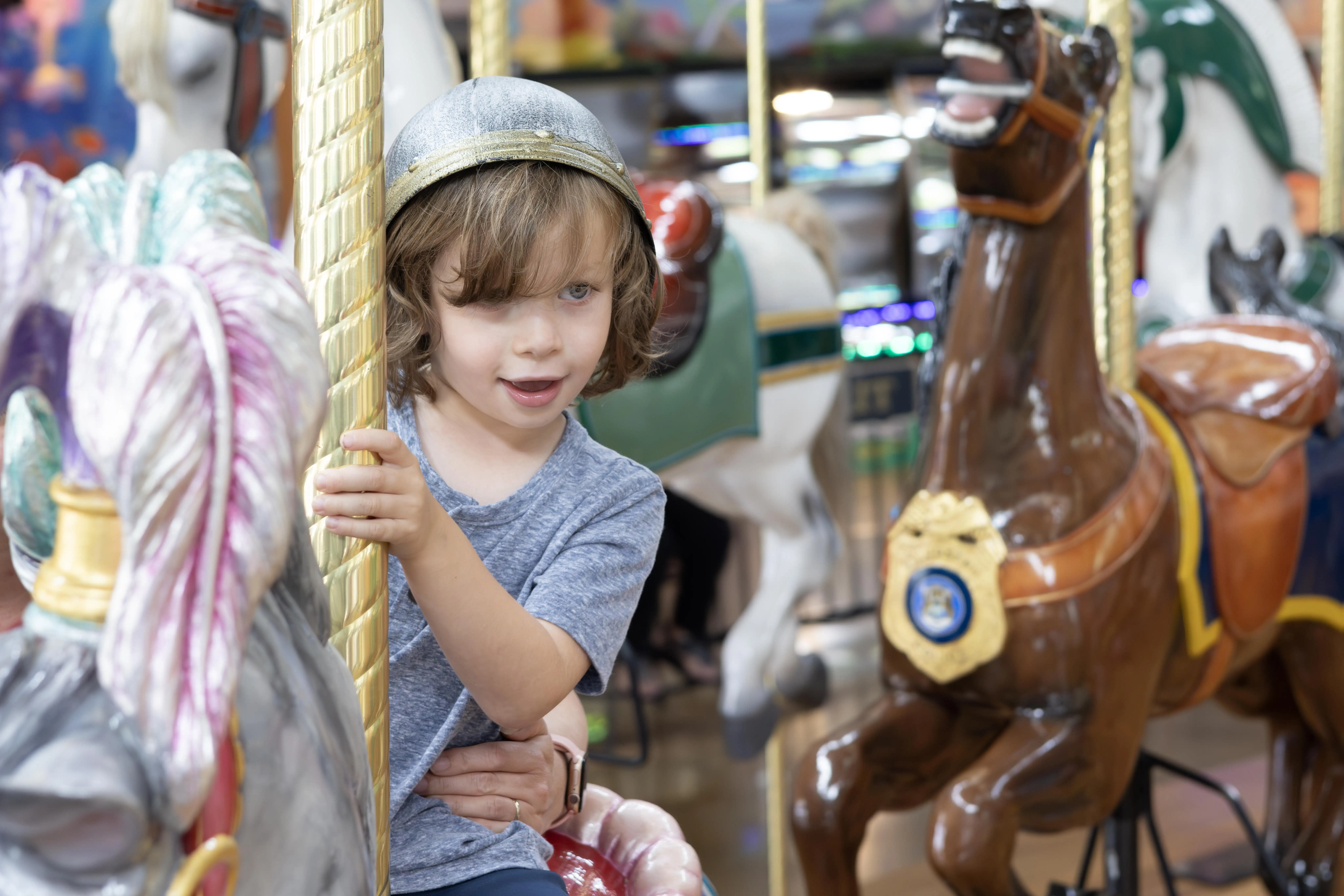 child on carousel hourse