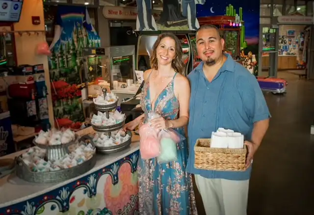 A couple standing near the refreshment stand.