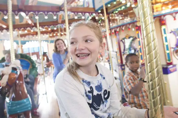 Happy guests riding the carousel.
