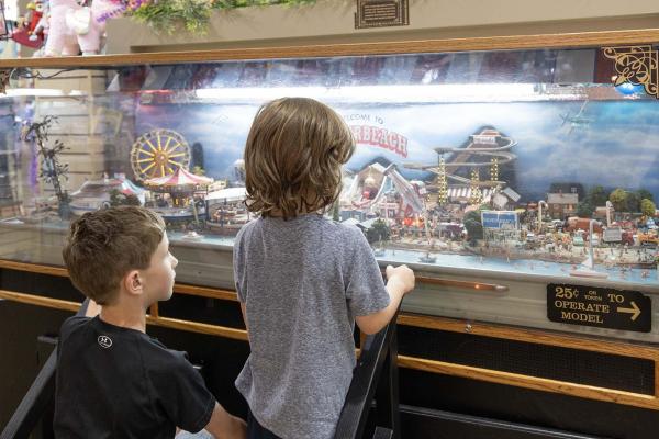 Kids enjoying looking at the Silver Beach Carousel Diorama.